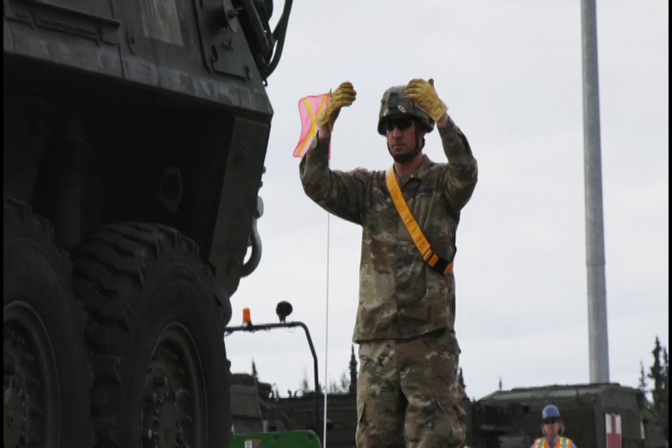 Soldier directs vehicle to move forward