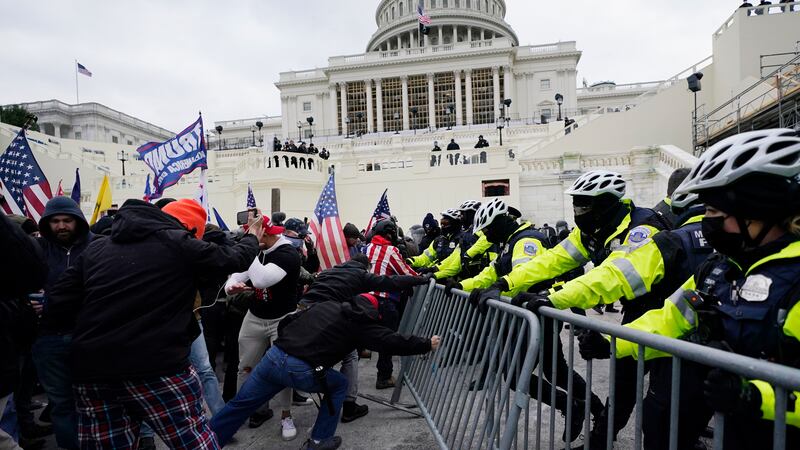 FILE - Violent insurrectionists loyal to President Donald Trump try to break through a police...