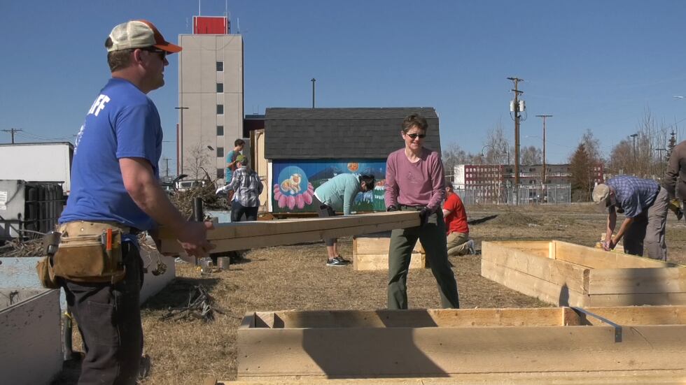 Volunteers constructing a new garden bed at Stone Soup Garden