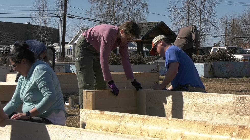 Volunteers constructing a new garden bed at Stone Soup Garden