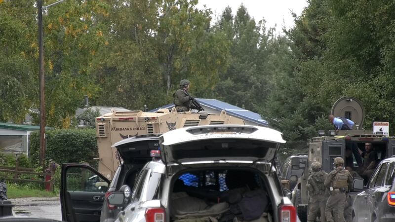 Members of the AST SERT team work to talk a suicidal man out of a car Monday morning.