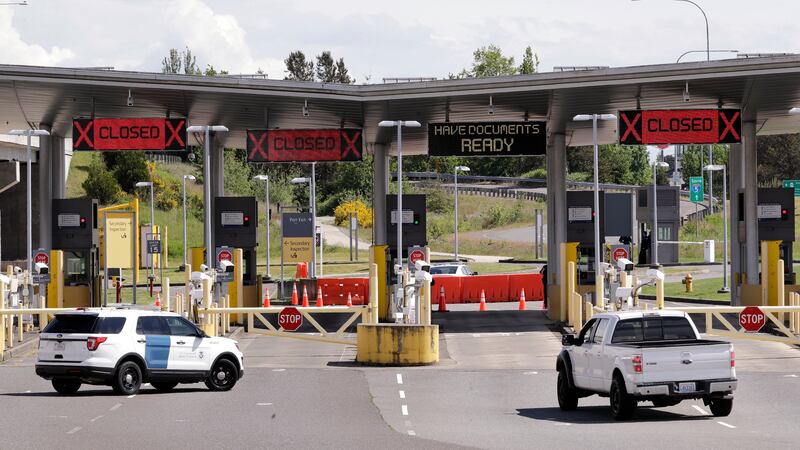 In this photo taken Sunday, May 17, 2020, a truck from Canada heads to the single open lane...
