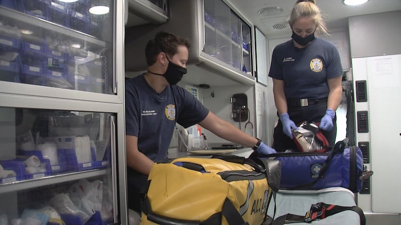 AFD firefighters Meghan McClain (left) and Catlin Clark (right) perform daily inventory checks...